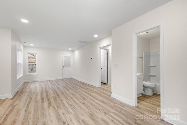 empty room with light hardwood / wood-style flooring