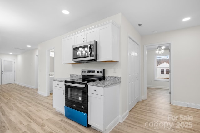 kitchen featuring white cabinetry, light stone countertops, and range with electric stovetop