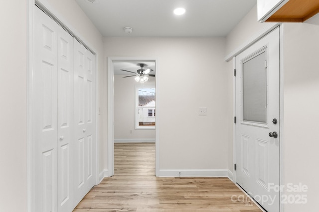 corridor with light hardwood / wood-style flooring