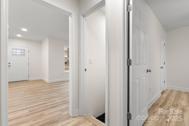 hall featuring plenty of natural light and light hardwood / wood-style floors