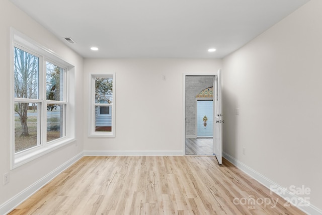 unfurnished room with light hardwood / wood-style floors