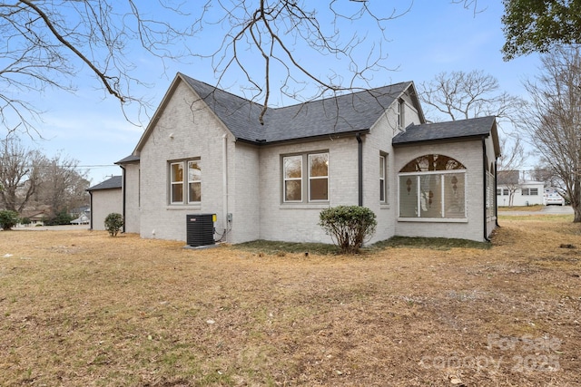 view of property exterior with cooling unit and a yard