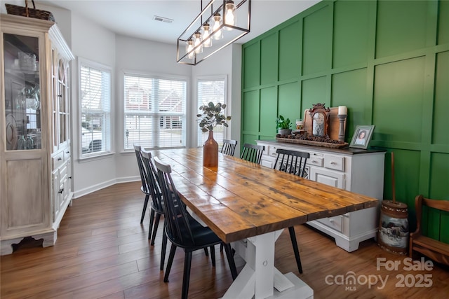 dining space featuring a healthy amount of sunlight and dark hardwood / wood-style floors