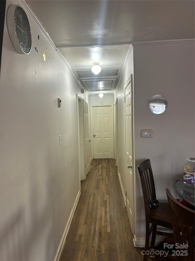 hallway with crown molding and dark wood-type flooring