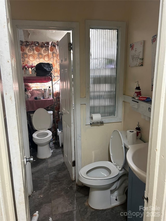 bathroom featuring toilet and sink