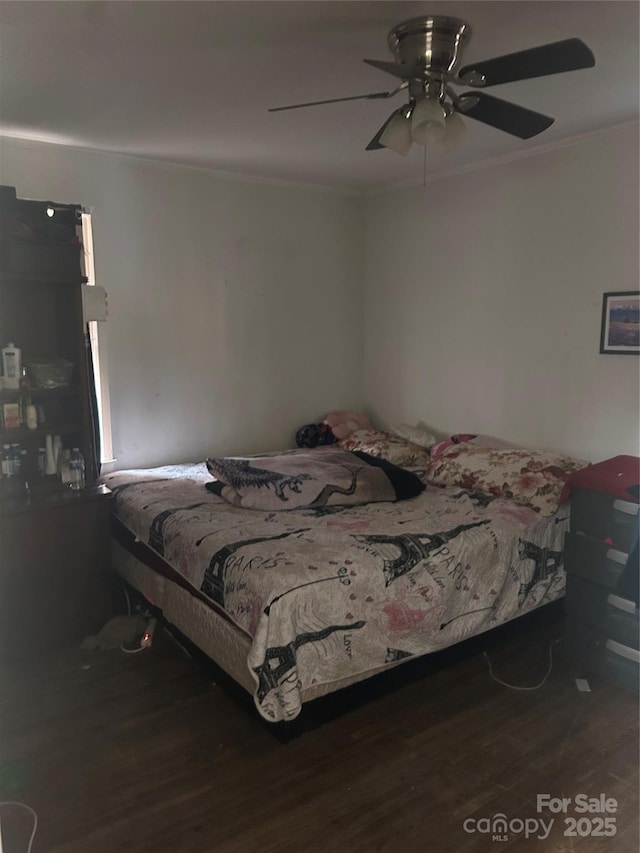 bedroom with ceiling fan, ornamental molding, and dark hardwood / wood-style floors