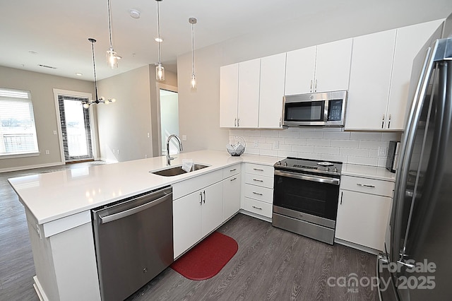 3630 N Davidson St, Charlotte, NC 28205 - kitchen featuring decorative light fixtures, sink, white cabinets, kitchen peninsula, and stainless steel appliances
