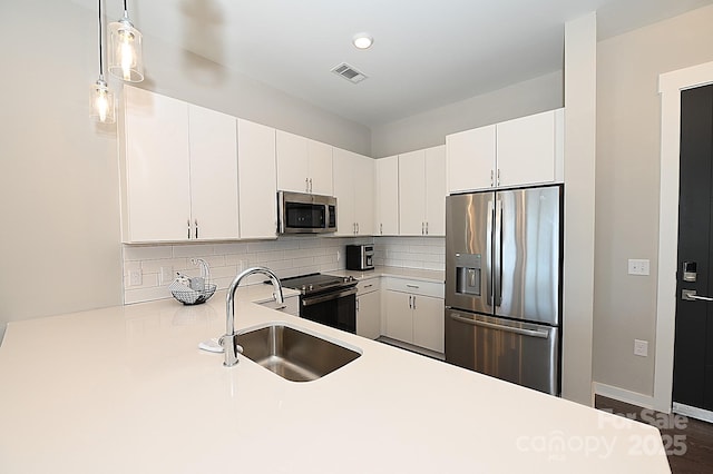 3630 N Davidson St, Charlotte, NC 28205 - kitchen featuring white cabinetry, sink, pendant lighting, and stainless steel appliances