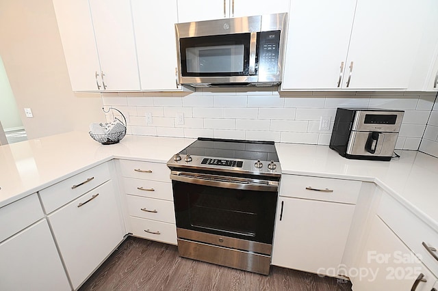 3630 N Davidson St, Charlotte, NC 28205 - kitchen with backsplash, appliances with stainless steel finishes, dark hardwood / wood-style floors, and white cabinets
