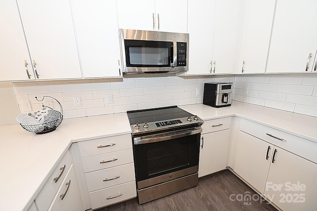3630 N Davidson St, Charlotte, NC 28205 - kitchen with white cabinetry, appliances with stainless steel finishes, dark hardwood / wood-style floors, and tasteful backsplash