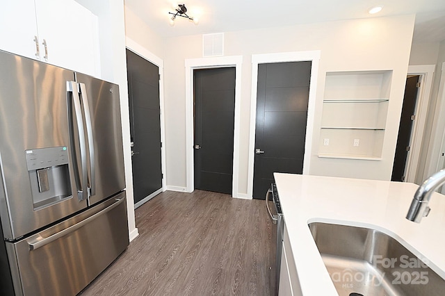 3630 N Davidson St, Charlotte, NC 28205 - kitchen with white cabinets, hardwood / wood-style flooring, sink, and stainless steel fridge
