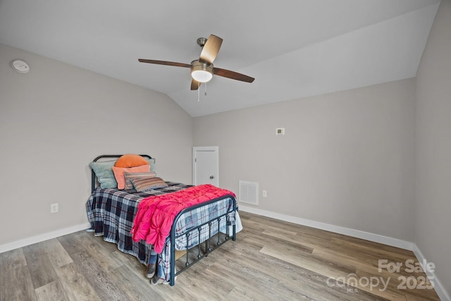 bedroom with vaulted ceiling, ceiling fan, and light hardwood / wood-style flooring