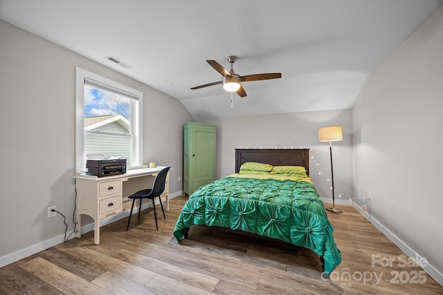 bedroom featuring ceiling fan, vaulted ceiling, and light hardwood / wood-style flooring