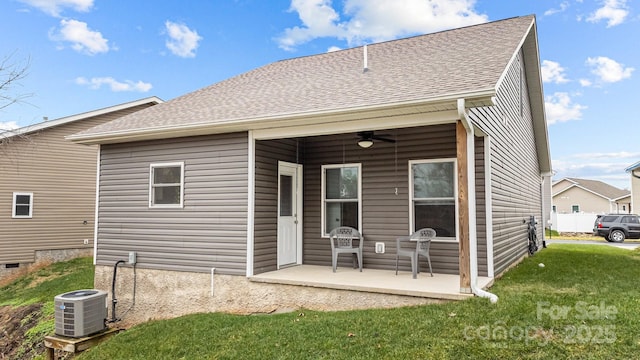 rear view of house featuring a yard, cooling unit, ceiling fan, and a patio area