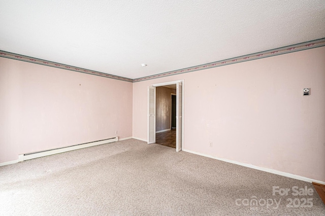 carpeted empty room featuring crown molding, a textured ceiling, and baseboard heating