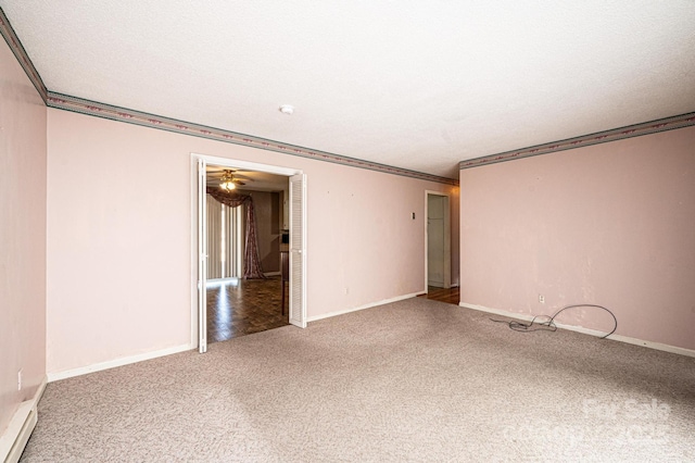 empty room featuring ornamental molding, carpet, and a textured ceiling