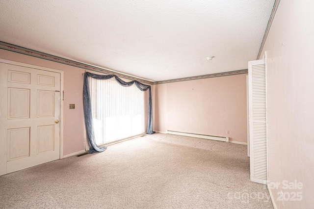 empty room with ornamental molding, carpet, a textured ceiling, and baseboard heating