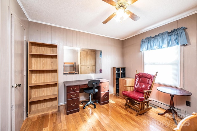 office area with a textured ceiling, ornamental molding, ceiling fan, light hardwood / wood-style floors, and a baseboard heating unit