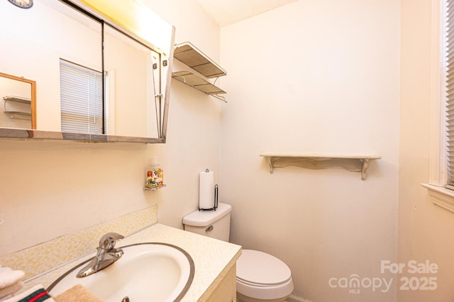 bathroom featuring vanity and toilet