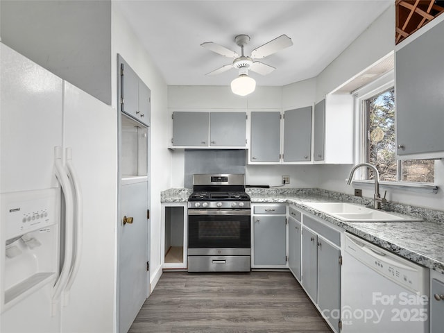 kitchen featuring ceiling fan, white appliances, a sink, gray cabinets, and dark wood finished floors