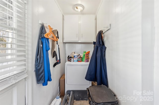 clothes washing area featuring washer / clothes dryer and cabinets