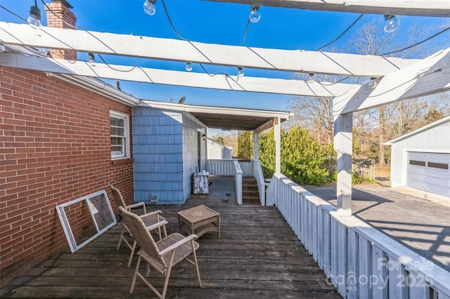 wooden terrace with an outbuilding and a garage