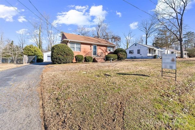 view of front of home with an outbuilding, a garage, and a front yard