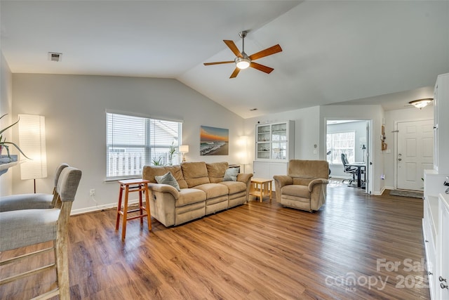 living room with vaulted ceiling, hardwood / wood-style floors, and ceiling fan