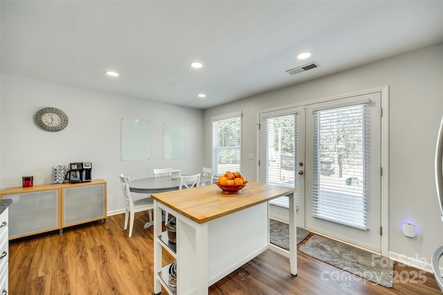 dining room with hardwood / wood-style flooring and french doors