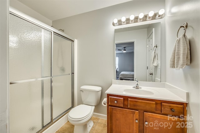 bathroom featuring vanity, tile patterned flooring, a shower with door, and toilet