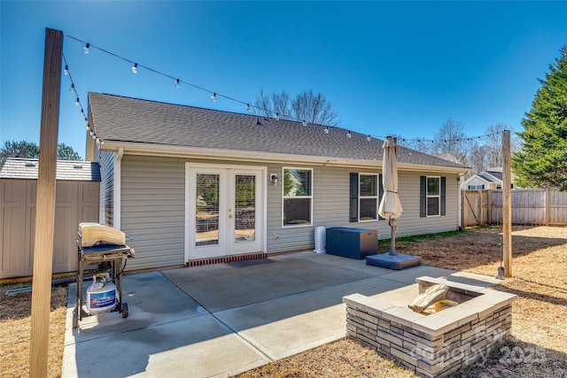 rear view of house featuring a patio and an outdoor fire pit