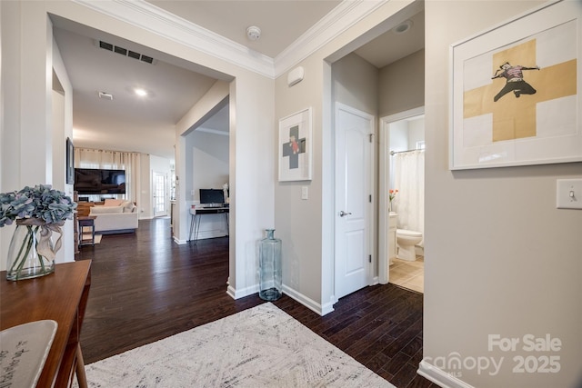 corridor featuring ornamental molding and dark hardwood / wood-style floors