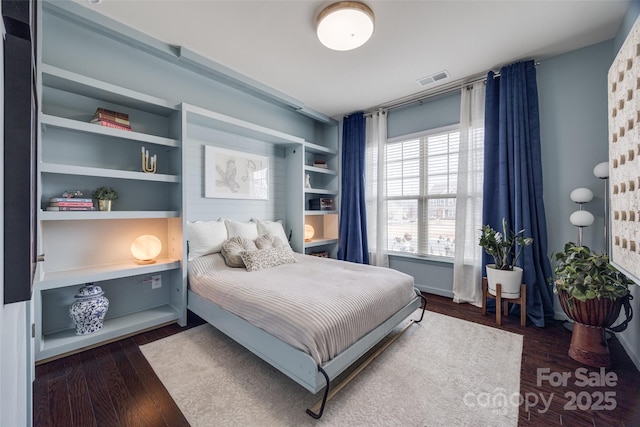 bedroom with dark hardwood / wood-style floors