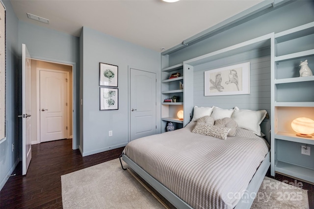 bedroom with dark wood-type flooring