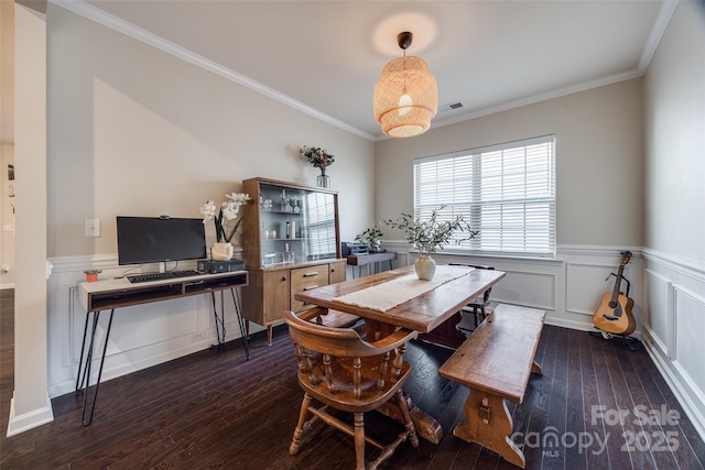 dining area with crown molding and dark hardwood / wood-style floors