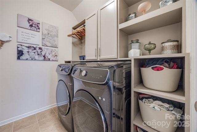 clothes washing area with cabinets, light tile patterned floors, and independent washer and dryer