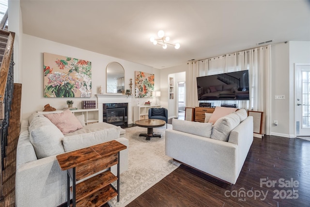 living room with a healthy amount of sunlight and dark hardwood / wood-style floors