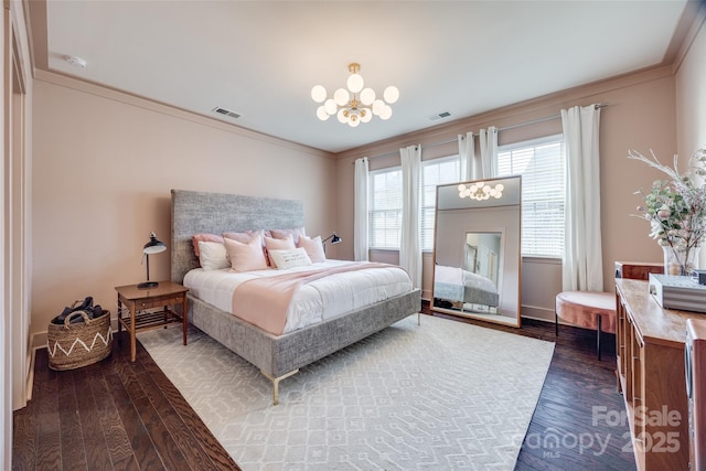 bedroom featuring ornamental molding, dark hardwood / wood-style flooring, and a notable chandelier