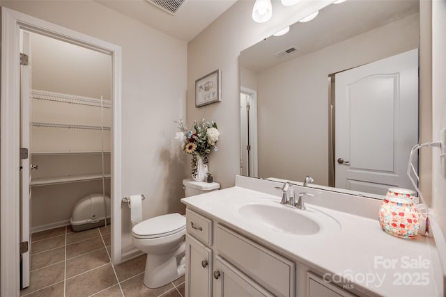 bathroom featuring vanity, toilet, and tile patterned flooring