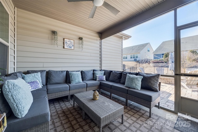 sunroom / solarium featuring ceiling fan