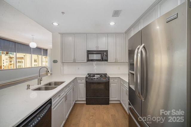 kitchen with gray cabinetry, sink, and black appliances