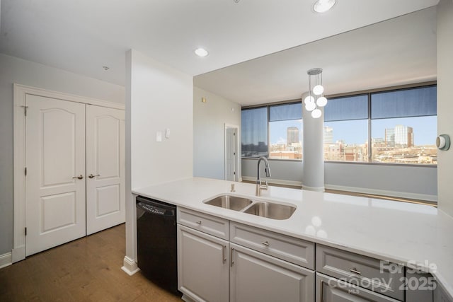 kitchen with hanging light fixtures, dishwasher, hardwood / wood-style flooring, and sink