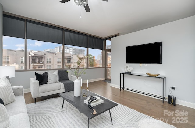 living room with wood-type flooring and ceiling fan