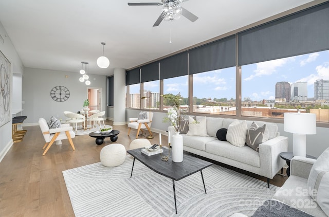 living room with ceiling fan and light wood-type flooring