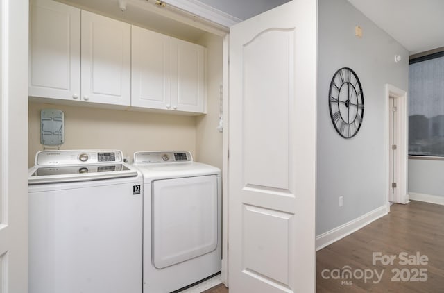 washroom with hardwood / wood-style flooring, cabinets, and washer and dryer