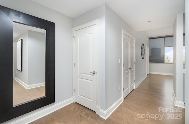 hallway with light wood-type flooring