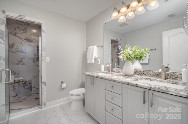 bathroom featuring an enclosed shower, vanity, tile patterned floors, and toilet