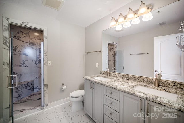 bathroom featuring vanity, an enclosed shower, and toilet