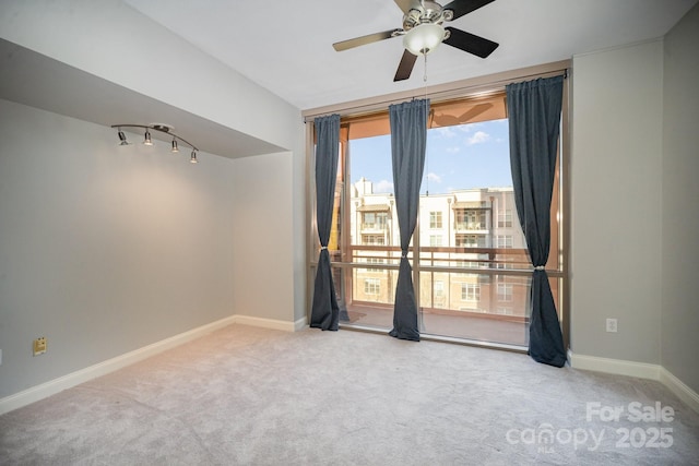 unfurnished room featuring ceiling fan and carpet