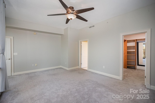 carpeted empty room with ceiling fan